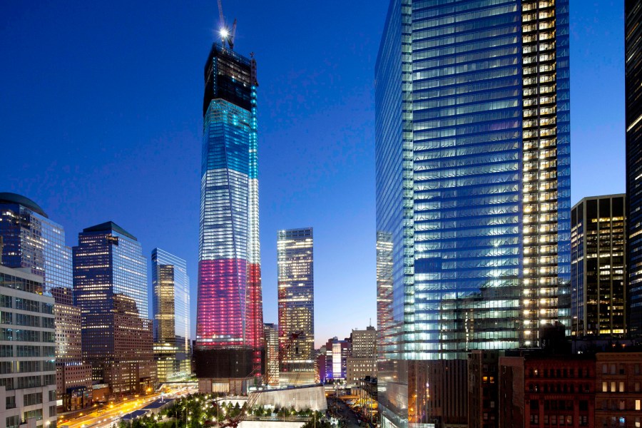 The tower known as 1 World Trade Center, left, the National September 11 Memorial, bottom left, and 4 World Trade Center, right, are bathed in light, Tuesday, Sept. 11, 2012 in New York. Tuesday is the eleventh anniversary of the terrorist attacks of...
