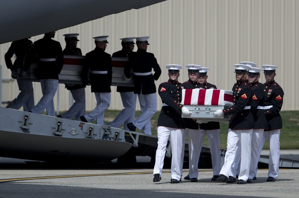 Carry teams move flag draped transfer cases of the remains of the four Americans killed this week in Benghazi, Libya, from a transport plane. Sept. 14, at Andrews Air Force Base.