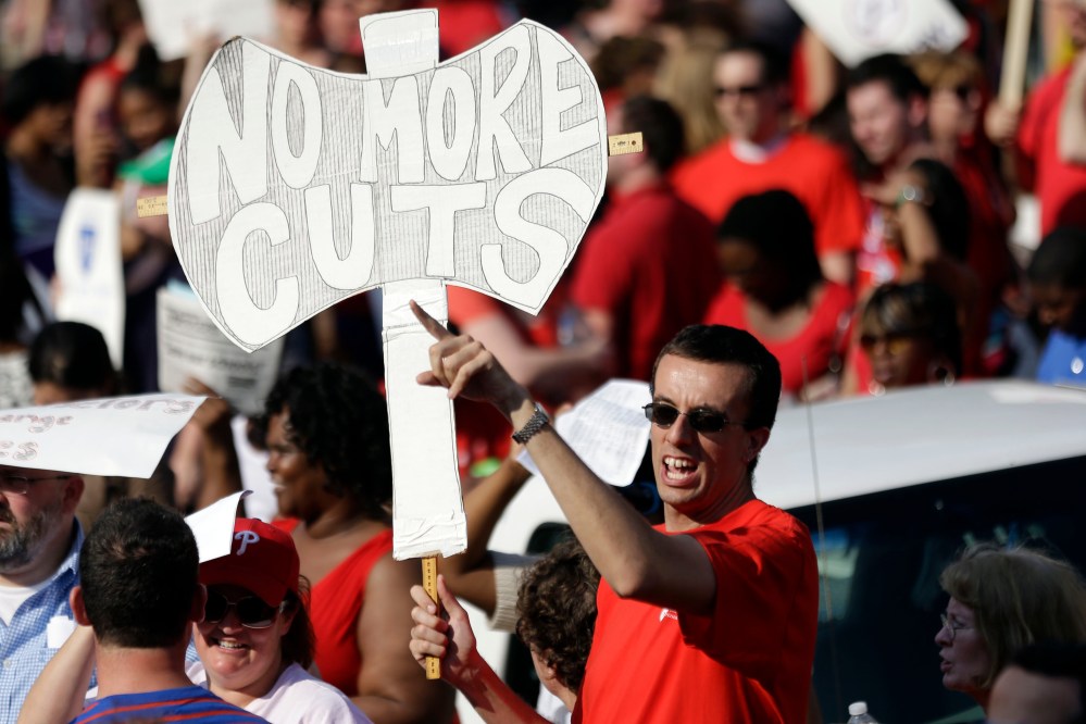 Demonstrates protest outside the school district headquarters, Thursday, May 30, 2013, in Philadelphia. (AP Photo/Matt Rourke)