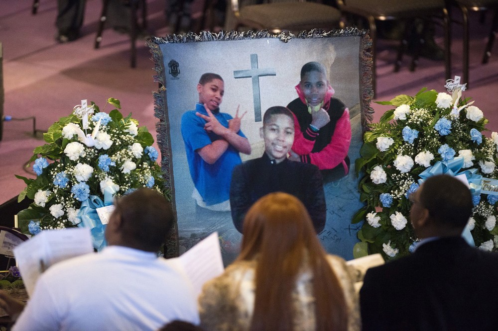 Family and friends sit and listen to kinds words being spoke during a memorial set up for Tamir Rice during the memorial ceremony for Tamir Rice, at the Mt. Sinai Baptist CHurch in Cleveland on Wednesday, Dec. 3, 2014.