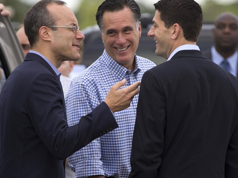 Republican presidential candidate Mitt Romney talks with foreign policy adviser Dan Senor (left) and his vice presidential running mate, Rep. Paul Ryan, R-Wis., before boarding his campaign plane at Daytona International Airport, Oct. 20 in Daytona...