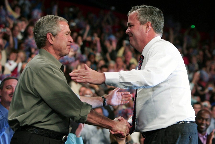 Former president George W. Bush greets his brother, former Florida Governor Jeb Bush, at a Republican Party congressional mid-term election campaign rally in Pensacola, Fla, Nov. 6, 2006. (Photo by Jason Reed/Reuters)