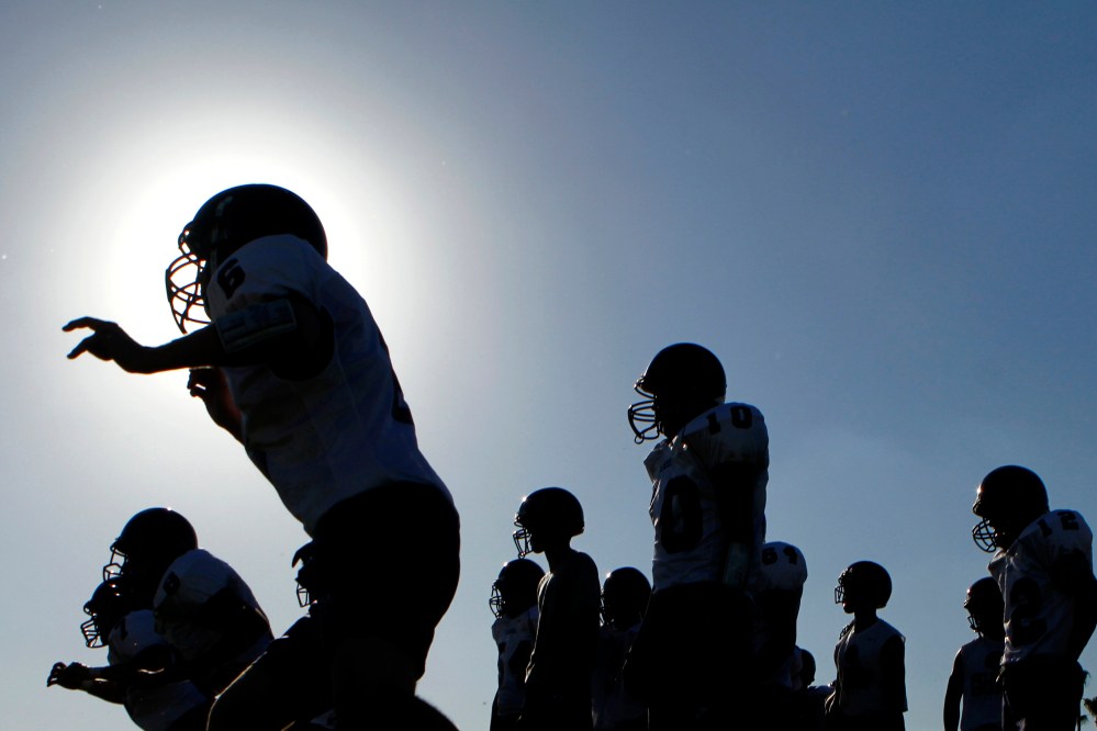 A high school football team at a practice.