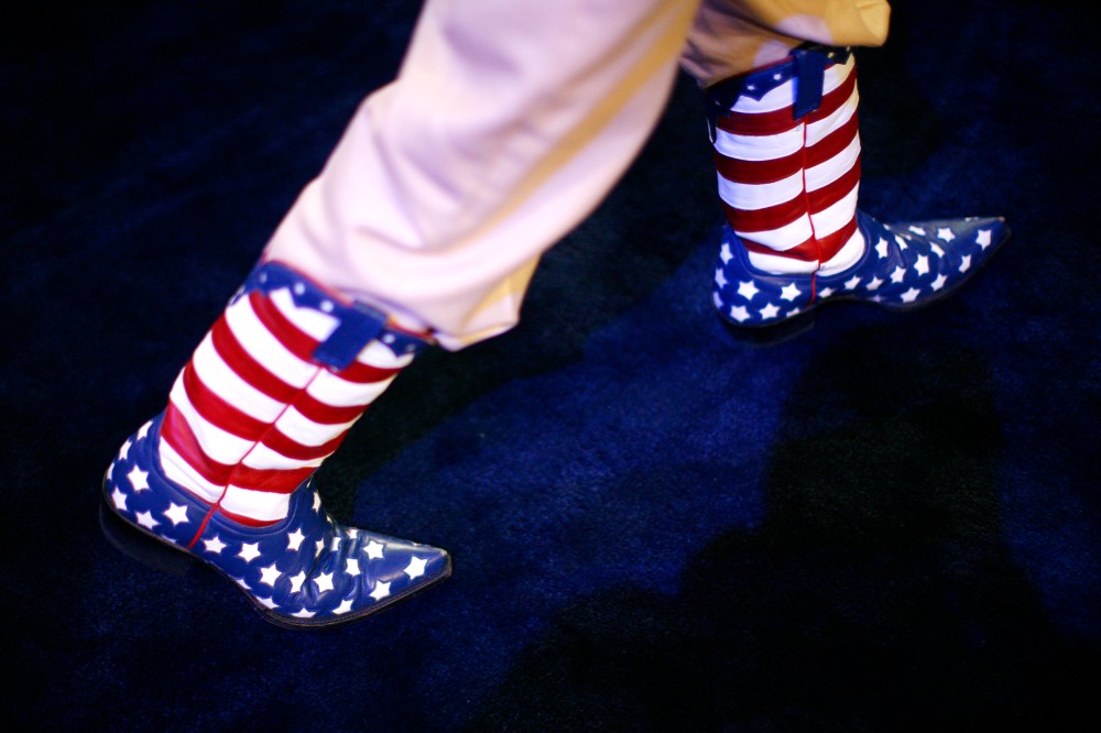 A participant walks the convention floor in Stars and Stripes cowboy boots during the second day of the Republican National Convention, Aug. 28, 2012 in Tampa, Fla.