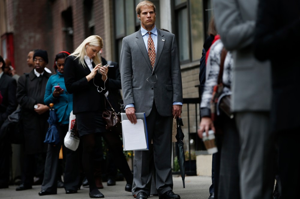 Job seekers stand in line to meet prospective employers at a career fair in New York City