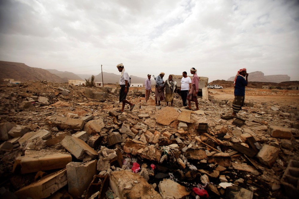 Tribesmen stand on the rubble of a building destroyed by a U.S. drone strike that killed Abdulrahman al-Awlaki, the son of slain U.S.-born cleric Anwar al-Awlaki.