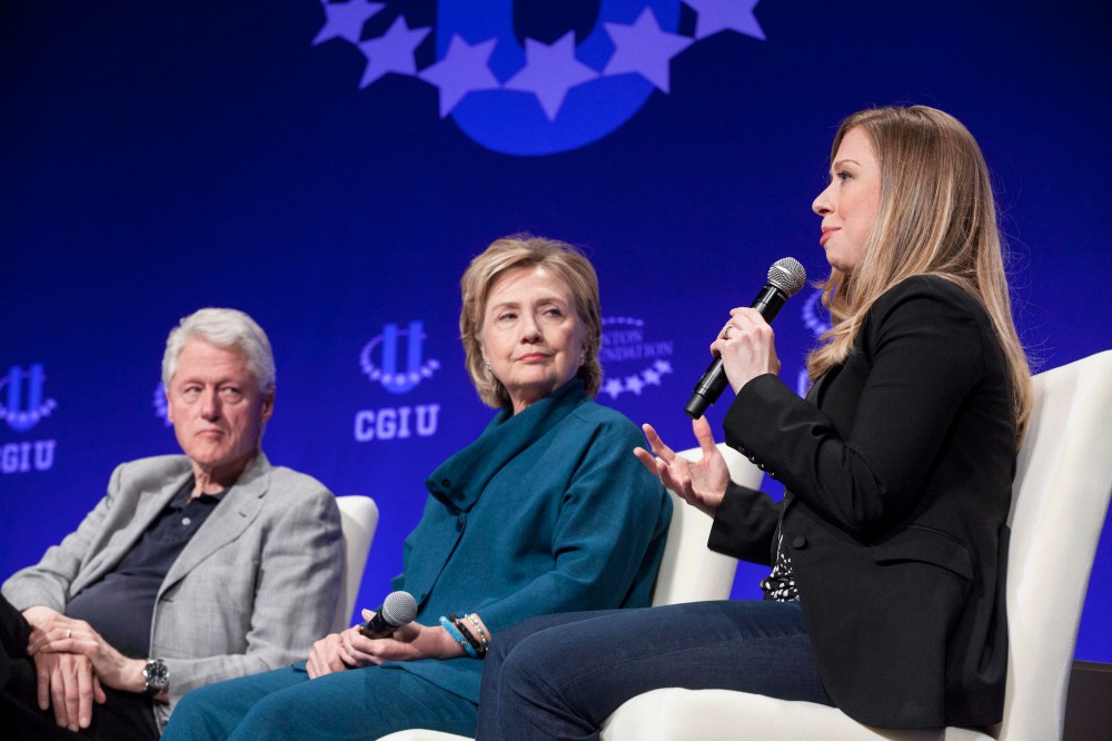 Former President Bill Clinton and former Secretary of State Hillary Clinton listen to their daughter and Vice Chair of the Clinton Foundation Chelsea Clinton in Tempe, Arizona on March 22, 2014. (Photo by Samantha Sais/Reuters)