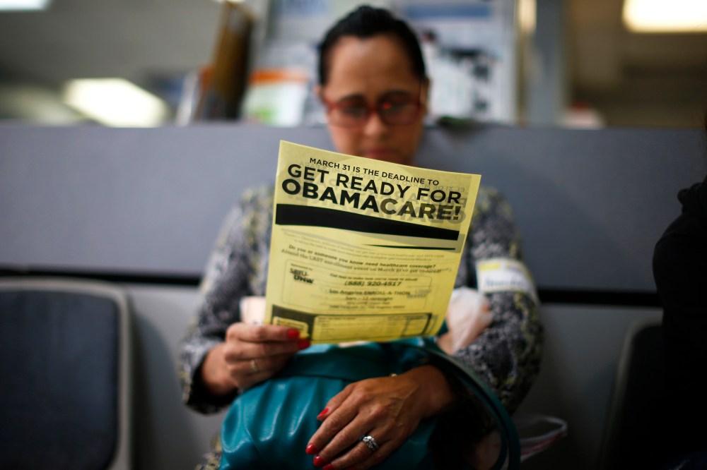 A woman reads a leaflet at a health insurance enrollment event in Cudahy, Calif., March 27, 2014