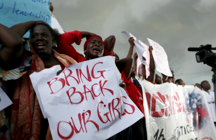 Women react during a protest demanding security forces to search harder for 200 abducted schoolgirls, outside Nigeria's parliament in Abuja