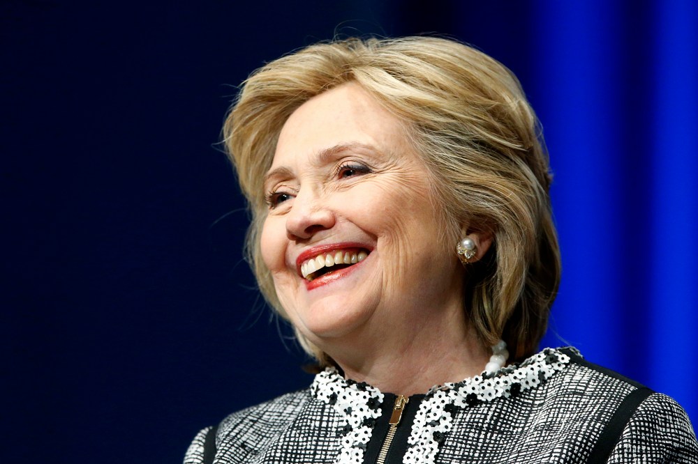Former U.S. Clinton smiles during a lengthy ovation for her at the start of an event on empowering woman and girls, at the World Bank in Washington