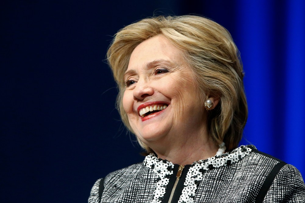 Former U.S. Secretary of State Hillary Clinton smiles during a lengthy ovation for her at the start of an event on empowering woman and girls, at the World Bank in Washington May 14, 2014.