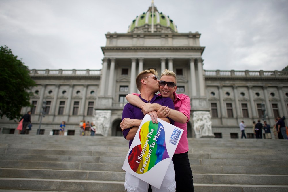 A couple embraces on the Pennsylvania State Capital steps following a rally with gay rights supporters in Harrisburg
