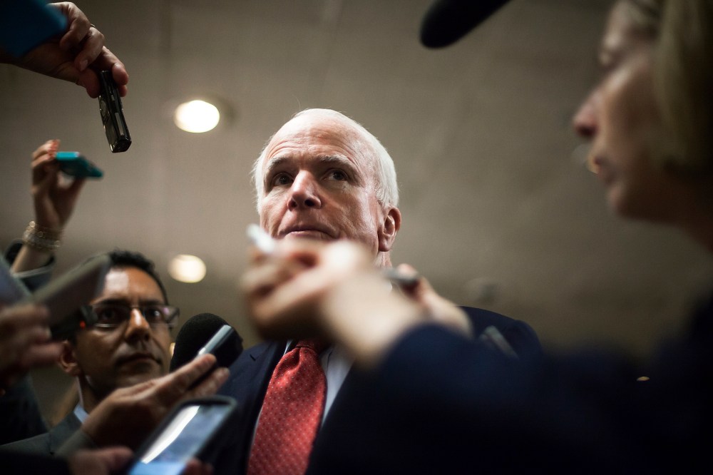 U.S. Senator John McCain talks to reporters at the U.S. Capitol in Washington, June 10, 2014.