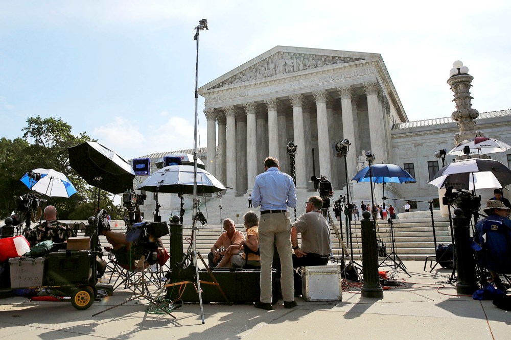 Numerous news crews await outside the Supreme Court in Washington June 25, 2014.