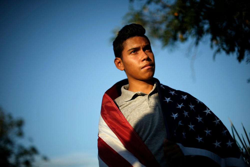 William Bello, 16, listens to speakers at a vigil in support of refugee children and their families in Murrieta, Calif. on July 9, 2014.