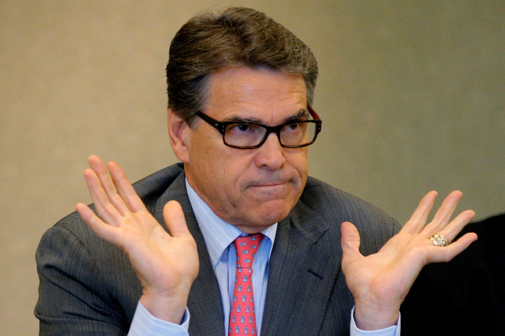 Texas Governor Perry answers question about indictment in Texas on two felony counts of abuse of power during appearance at business leaders luncheon in Portsmouth