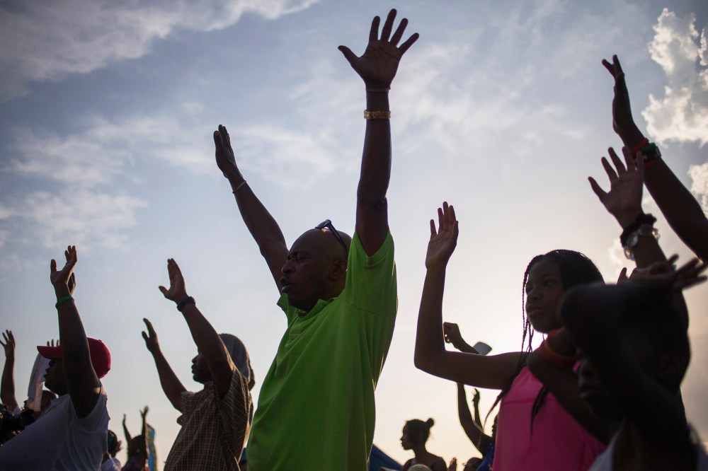 Supporters of Michael Brown, raise their hands in solidarity at the the Peace Fest 2014 rally in St. Louis, Missouri on Aug. 24, 2014. (Photo by Adrees Latif/Reuters)