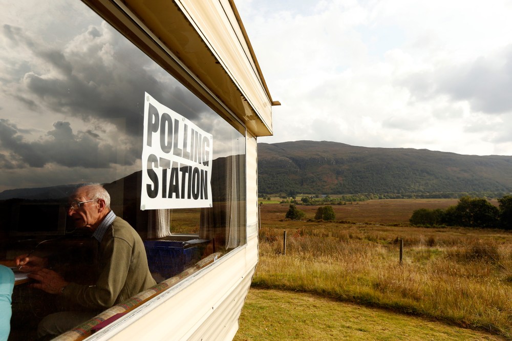 Poll clerk George MacKay sits in the Coulags caravan polling station, in the Scottish Highlands Sept. 18, 2014.