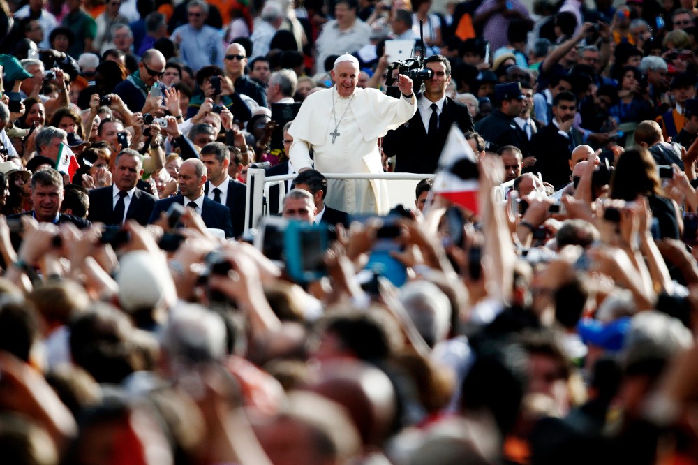 Pope Francis waves as he leads his weekly audience in Saint Peter's Square at the Vatican on Oct. 1, 2014. (Photo by Tony Gentile/Reuters)