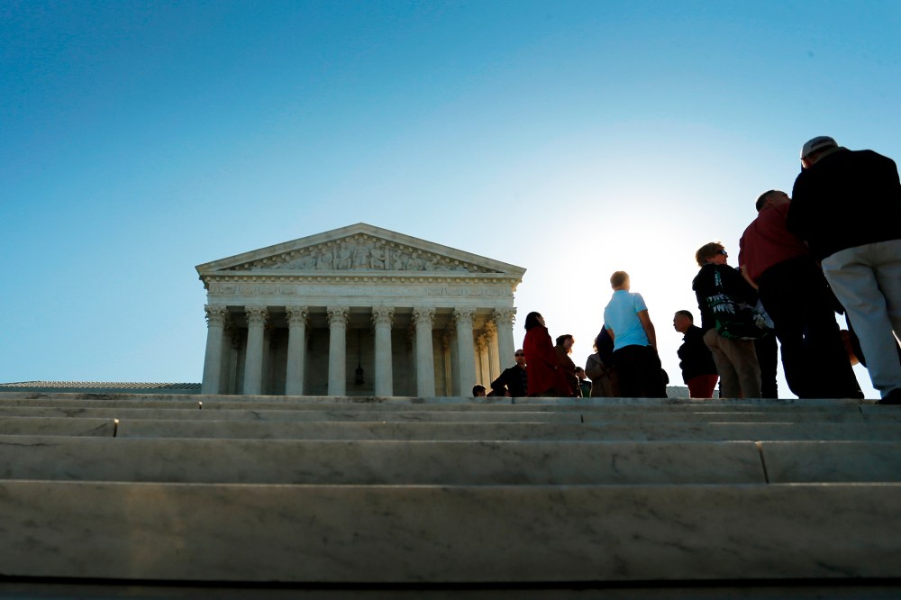 Visitors stand in line to watch arguments on the first day of the new term of the U.S. Supreme Court in Washington on Oct. 6, 2014. (Photo by Jonathan Ernst/Reuters)