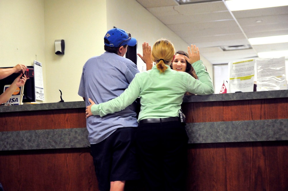 Jennifer Hasler (L) and Karina Tittjung take an oath to receive their marriage license at the Oklahoma County courthouse in Oklahoma City, Oklahoma on Oct. 6, 2014.