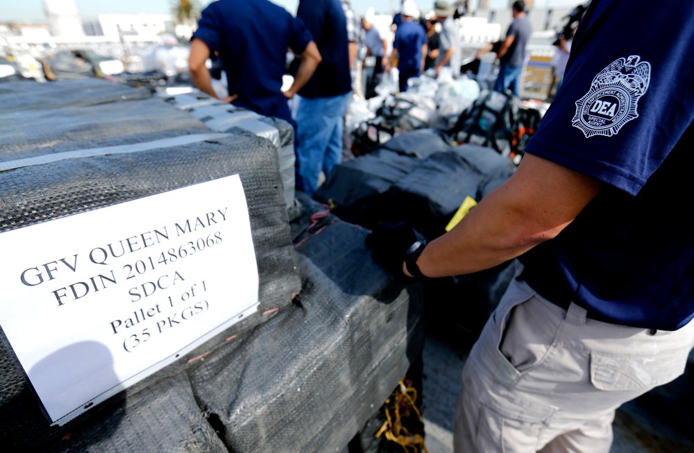 Drug Enforcement Agency (DEA) agents take inventory of seized cocaine packages, on the deck of the US Coast Guard Cutter Boutwell at Naval Base San Diego in San Diego, Oct. 6, 2014. (Photo by Mike Blake/Reuters)