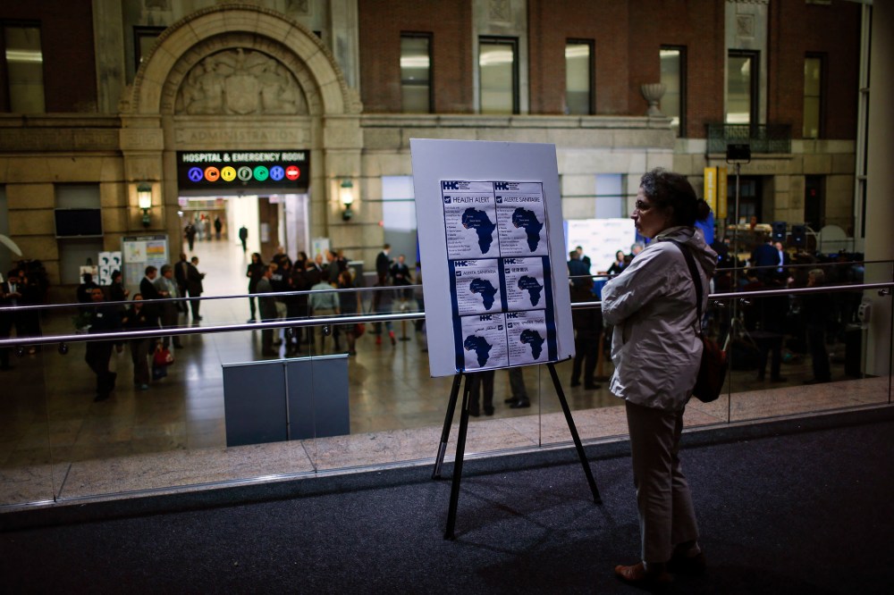 A woman reads alert on Ebola inside the Bellevue Hospital where Dr. Craig Spencer is being treated for Ebola symptoms in New York on Oct. 23, 2014.