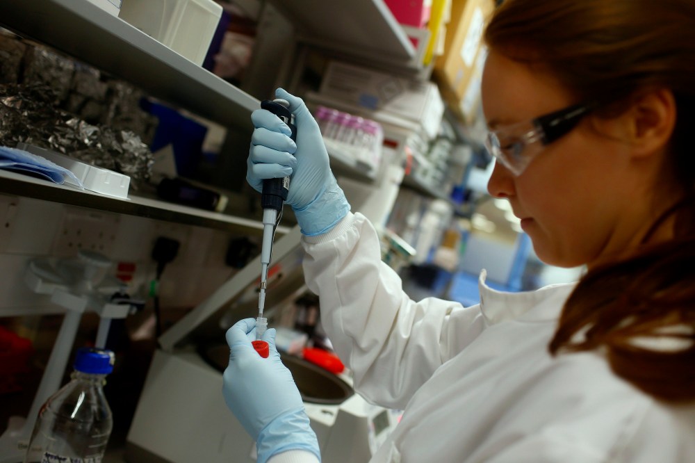 Research assistant Georgina Bowyer works on a vaccine for Ebola at The Jenner Institute in Oxford, southern England, Jan. 16, 2015. (Photo by Eddie Keogh/Reuters)