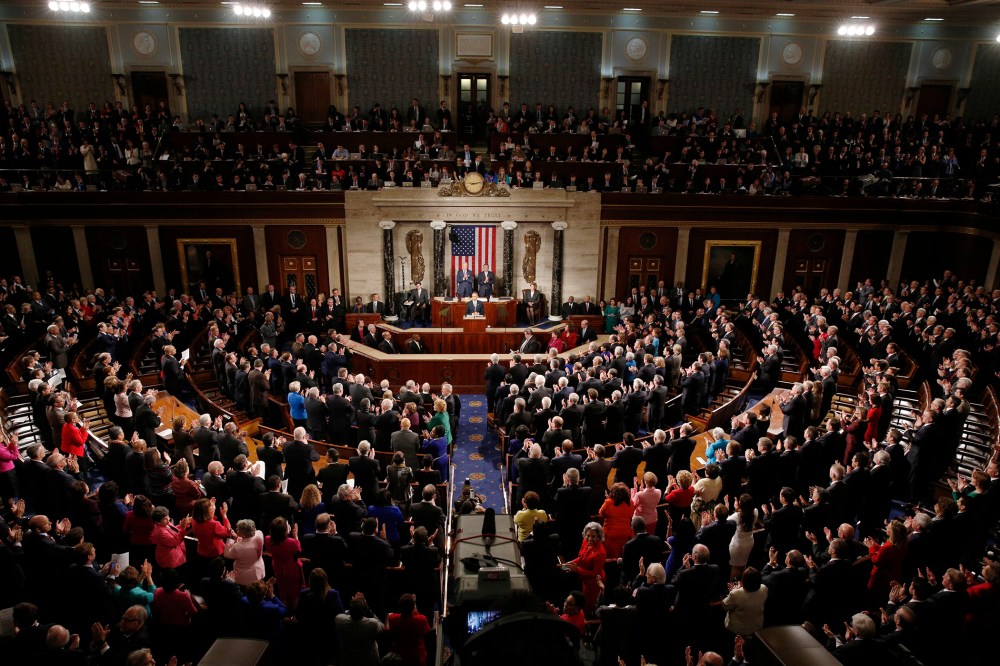 U.S. President Barack Obama (C) receives a standing ovation as he delivers his State of the Union address to a joint session of Congress in the U.S. Capitol in Washington, D.C., on Jan. 20, 2015. (Photo by Kevin Lamarque/Reuters)