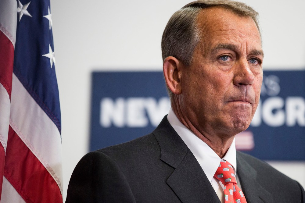 Speaker of the House Boehner listens as his fellow Republicans speak to the media after a conference meeting with House Republicans