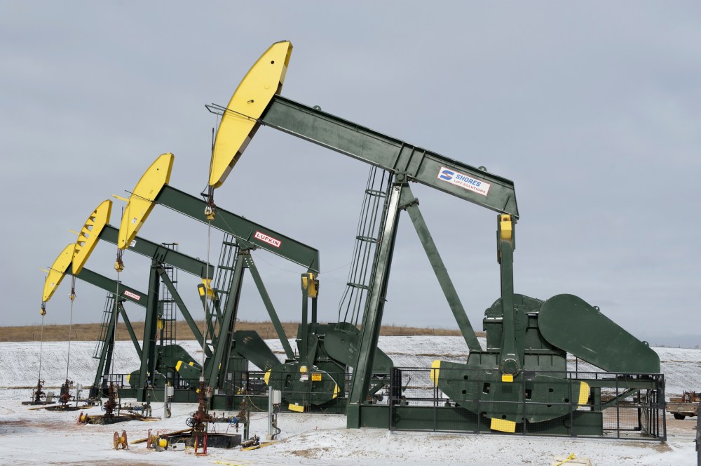 Pumpjacks taken out of production temporarily stand idle at a Hess site while new wells are fracked near Williston, ND, Nov. 12, 2014. (Photo by Andrew Cullen/Reuters)