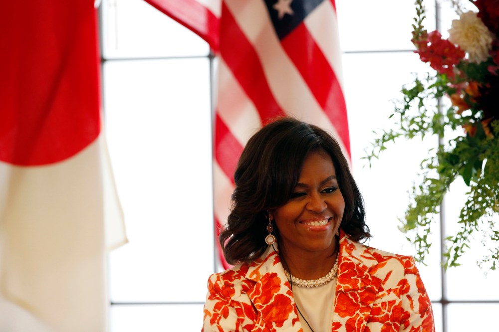 First Lady Michelle Obama smiles as she attends an event discussing education for girls at the Iikura Guest House in Tokyo March 19, 2015. (Photo by Issei Kato/Reuters)