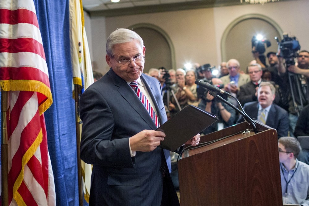 Senator Menendez exits the podium after speaking to the media during a news conference in Newark