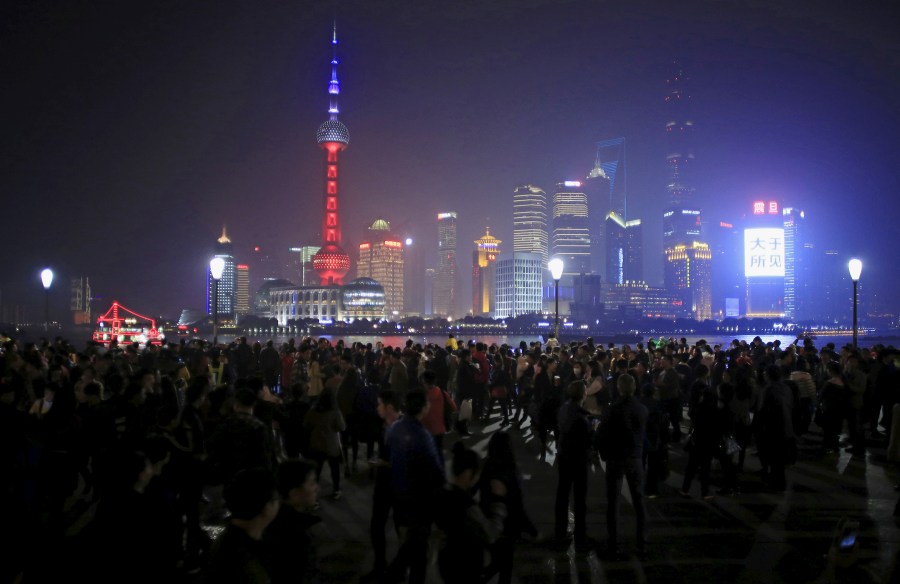 Shanghai's landmark building, The Oriental Pearl TV Tower, is lit up in blue, white and red, the colors of the French flag, following the Paris attacks, in Shanghai, China, Nov. 14, 2015. (Photo by Aly Song/Reuters)