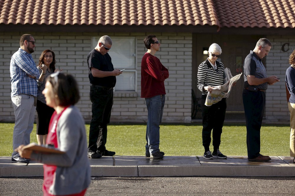 People wait to vote in the presidential primary election outside a polling site in Glendale, Ariz., March 22, 2016. (Photo by Nancy Wiechec/Reuters)