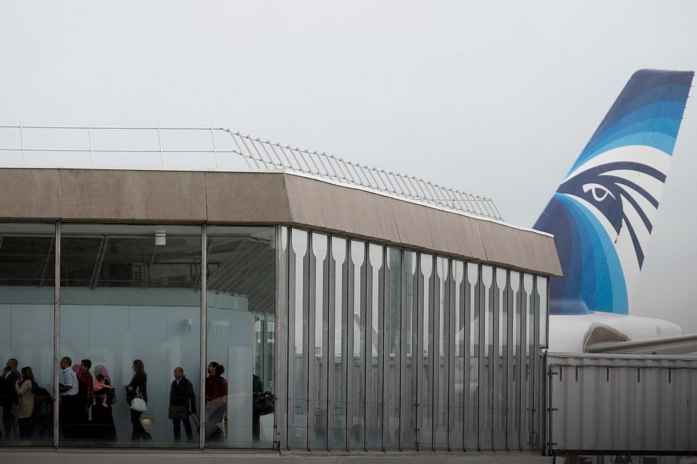 Passengers disembark from the incoming EgyptAir plane assuring the following flight from Paris to Cairo, after flight MS804 disappeared from radar, at Charles de Gaulle airport in Paris, France, May 19, 2016. (Photo by Christian Hartmann/Reuters)