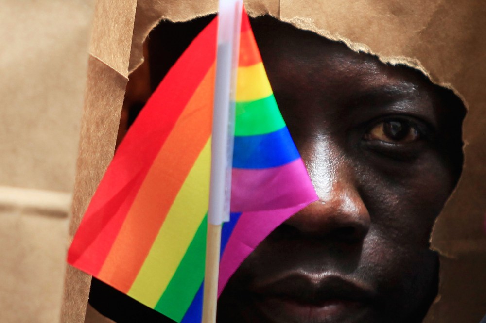 An asylum seeker from Uganda covers his face with a paper bag in order to protect his identity as he marches with the LGBT Asylum Support Task Force during the Gay Pride Parade in Boston, Mass. on June 8, 2013.