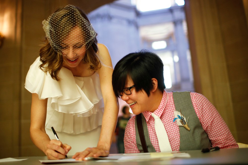 Ashlee Meyer (L) and partner KY Choi (R) sign their marriage license as they prepare to get married, June 29, 2013 at City Hall in San Francisco, Calif.