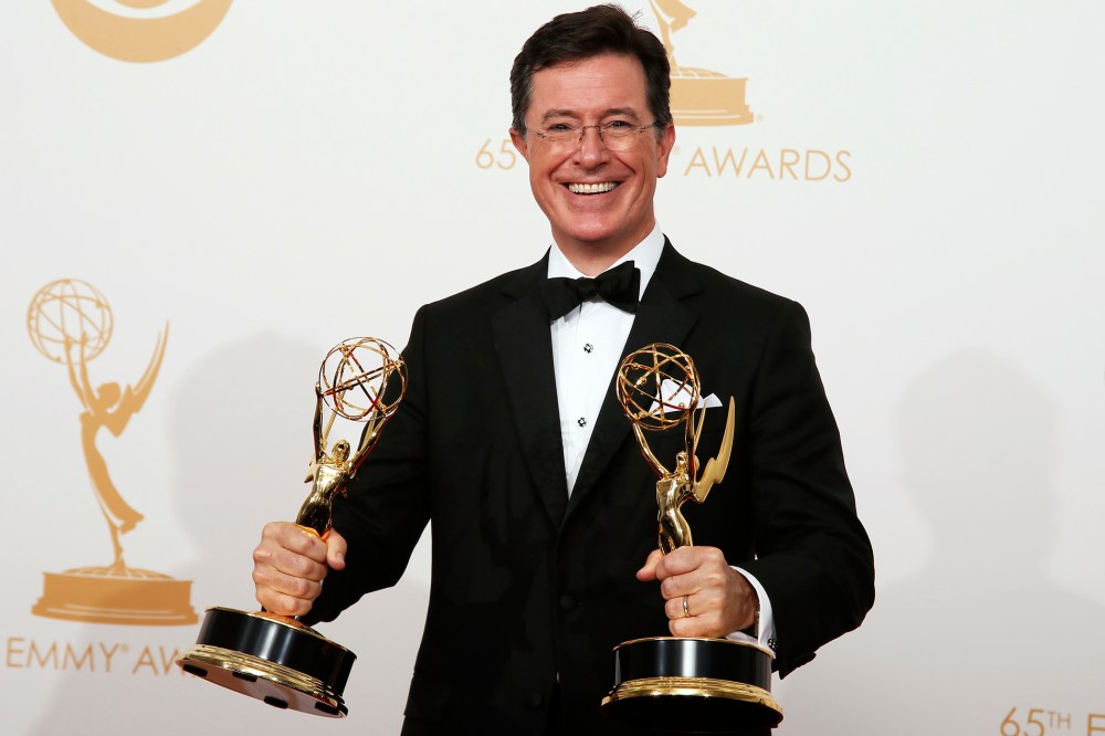Stephen Colbert poses backstage with his awards for Outstanding Variety Series and Outstanding Writing For A Variety Series at the 65th Primetime Emmy Awards in Los Angeles, Calif., Sept. 22, 2013.