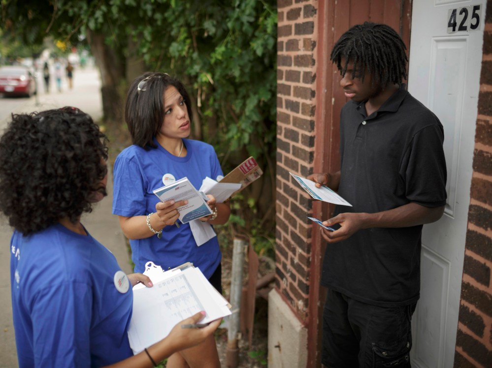 Get Covered America volunteers Cynae Derose and Jalisa Hinkle talk with Daniel Glover about the Affordable Care Act - also known as Obamacare - while canvassing a Chicago neighborhood