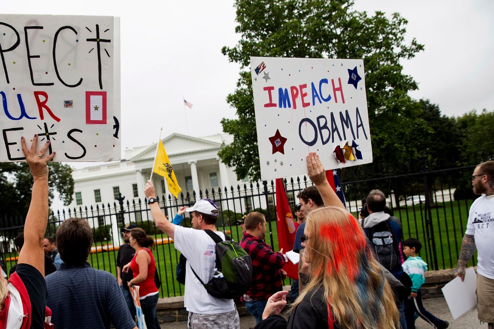 Protesters with the "Million Vet March on the Memorials" call for impeachment of U.S. President Barack Obama in front of the White House in Washington on Oct. 13, 2013.