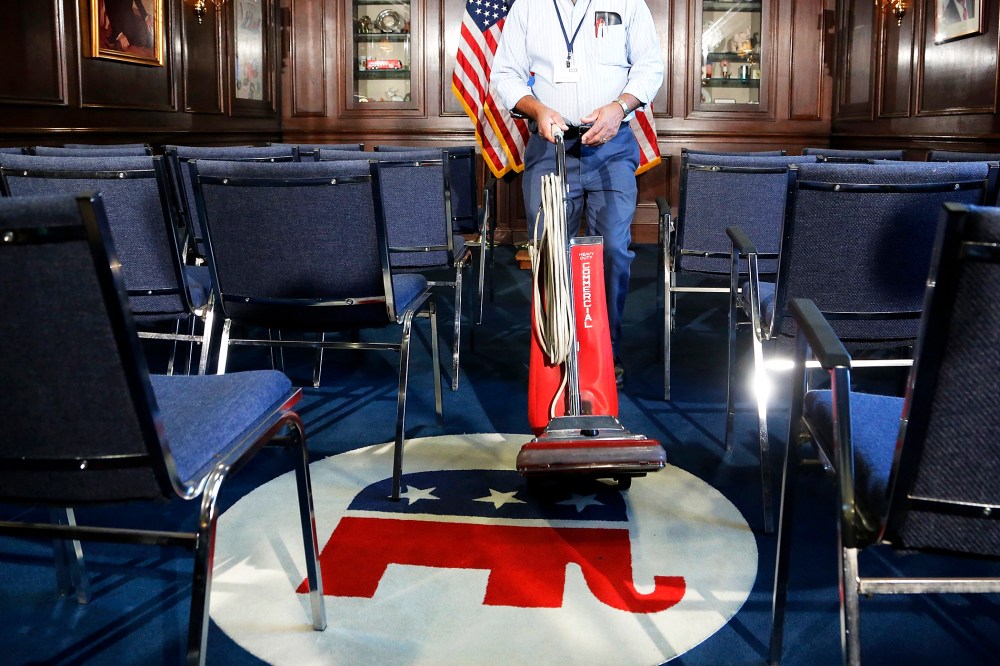 A worker prepares a room before a news conference by House Republican leaders at the Republican National Committee offices on Capitol Hill in Washington Oct. 23, 2013.