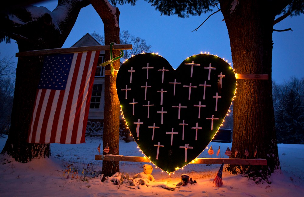 A heart that bears 26 crosses for each victim is surrounded by lights the Sandy Hook portion of Newtown, Connecticut Dec. 14, 2013.