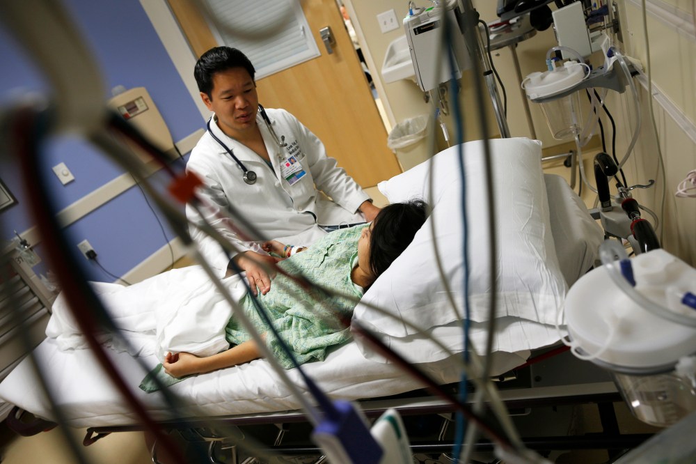 A patient speaks with Doctor Leon Yeh in the Emergency Room at OSF Saint Francis Medical Center in Peoria, Illinois, Nov. 26, 2013.
