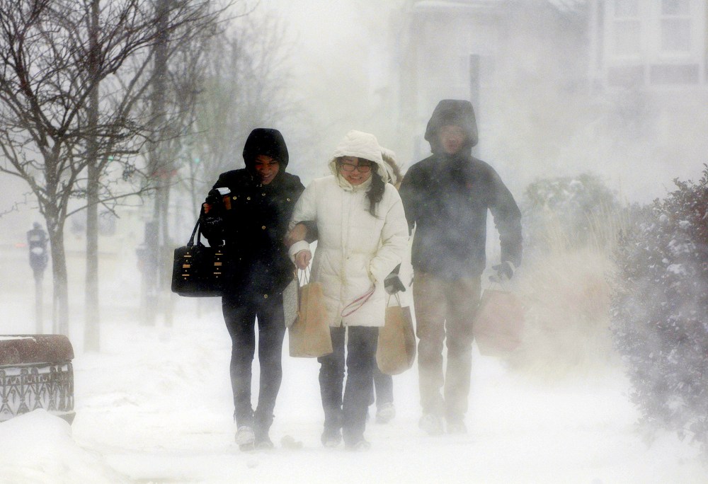 Elmwood Village residents after purchasing necessities from a grocery store, Buffalo, N.Y., Jan. 7, 2014. A deadly blast of arctic air shattered decades-old temperature records as it enveloped the eastern U.S. (Photo by Don Heupel/Reuters)