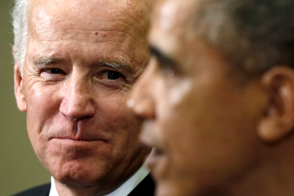 U.S. Vice President Joe Biden (L) listens as President Barack Obama speaks at the White House in Washington on Jan. 22, 2014.