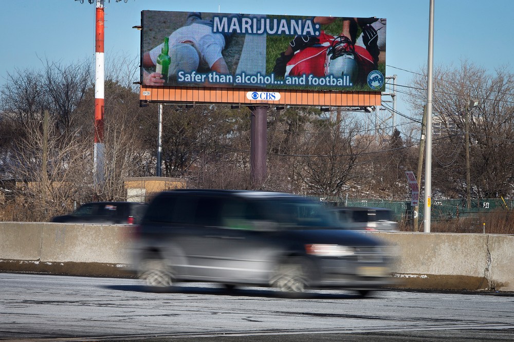 Cars drive past a billboard alongside a highway in Newark, New Jersey, Jan. 29, 2014.