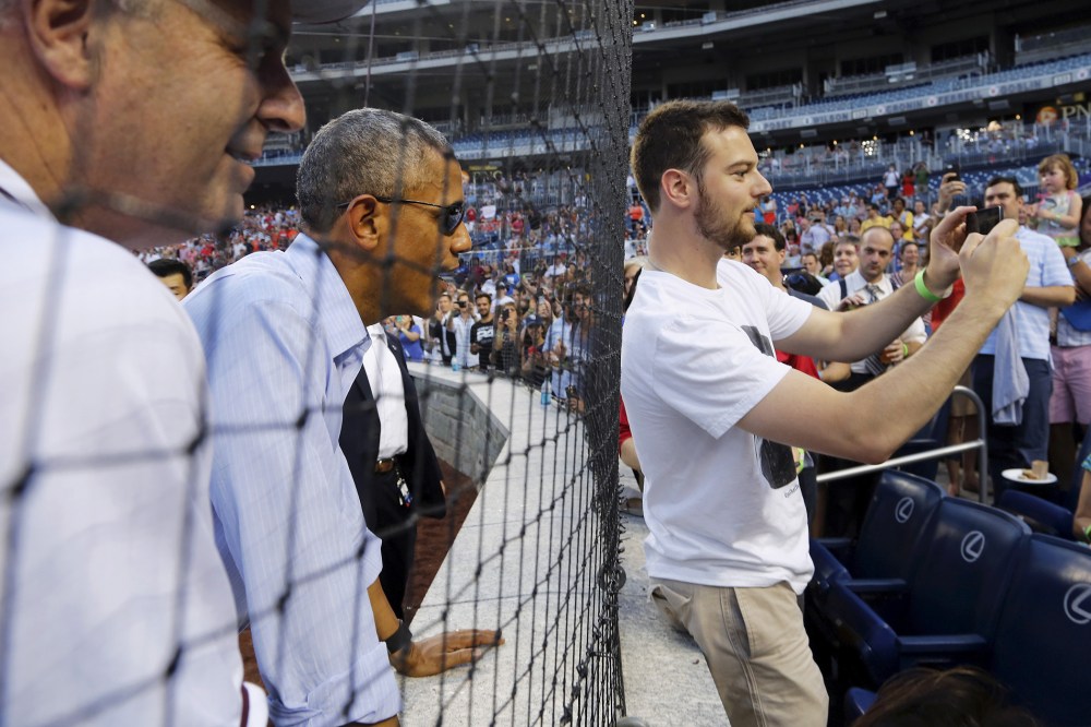 U.S. President Barack Obama interacts with fans at the annual Congressional Baseball Game, pitting Republicans against Democrats for charity, at Nationals Park in Washington June 11, 2015. (Photo by Jonathan Ernst/Reuters)