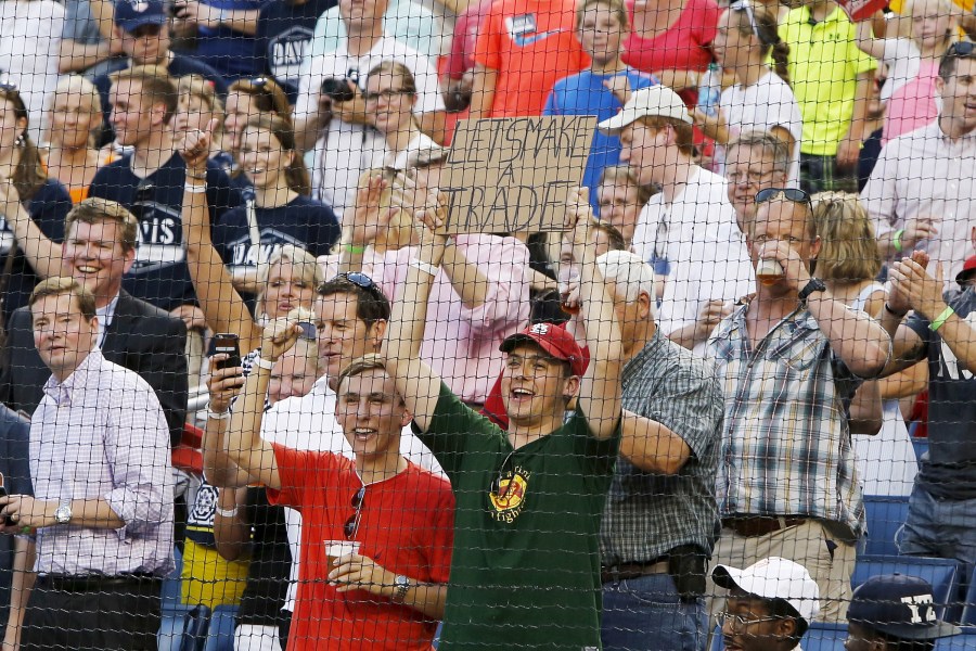 A fan holds a sign reading 