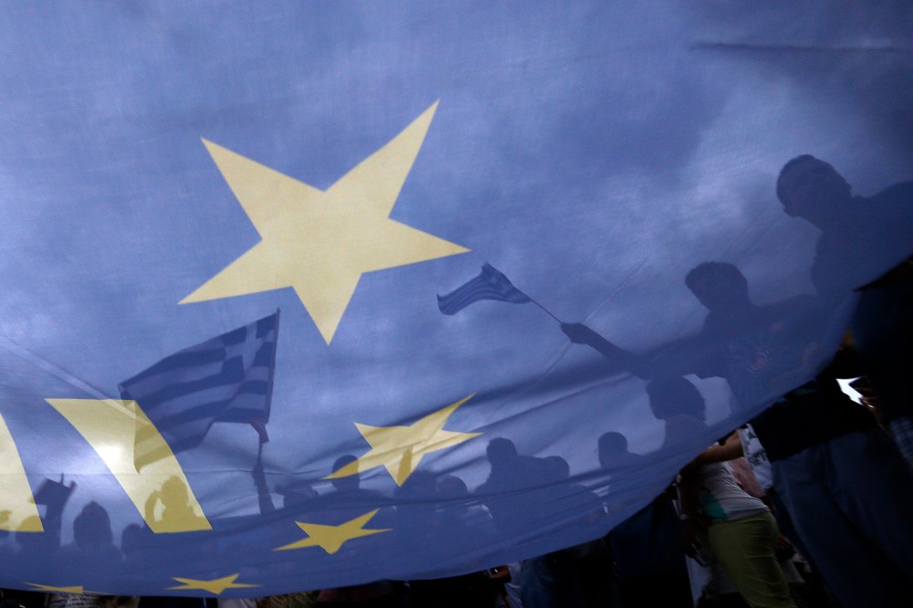 Pro-Euro protestors hold European Union flags during a pro-Euro rally in front of the parliament building in Athens, Greece on Jun. 30, 2015. (Photo by Yannis Behrakis/Reuters)